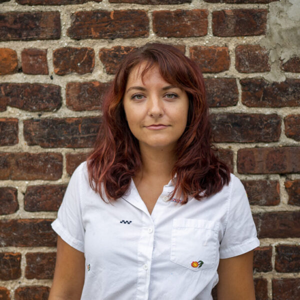 Headshot of Calyssa Kremer in front of brick wall