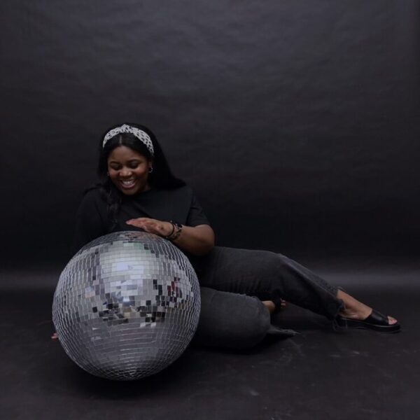 Photo of Arianna Gordon holding a silver disco ball