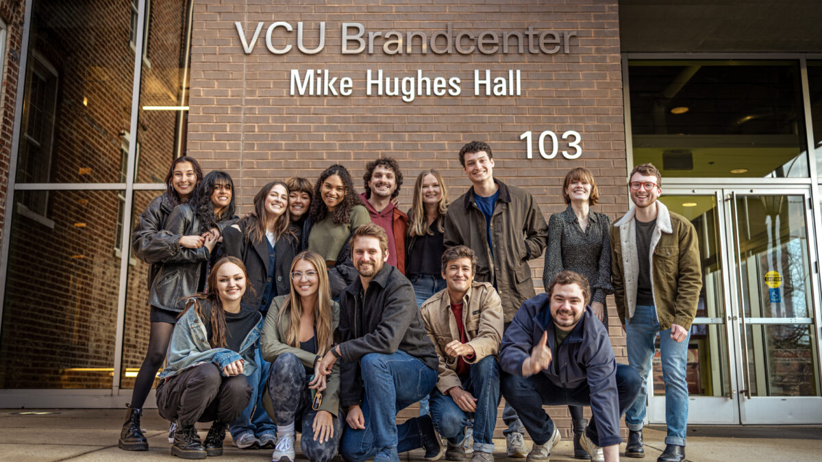A group of students pose at the front of the Brandcenter