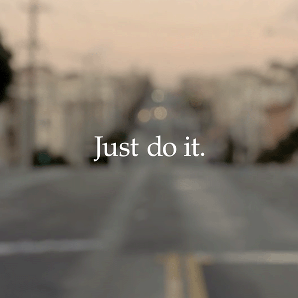A screenshot of a Nike commercial with Just do it on the screen with a city background