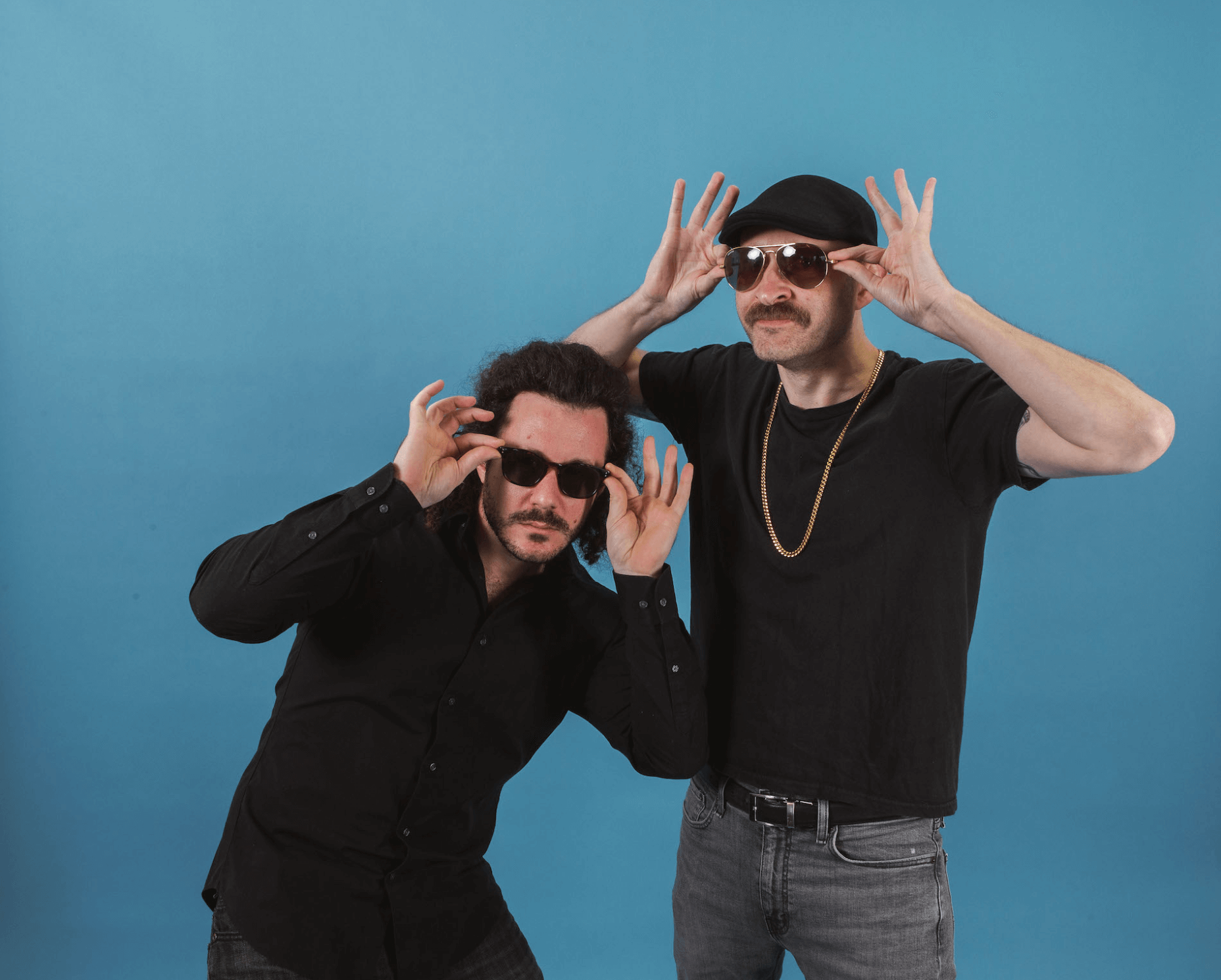 Photo of Frank and Jeff posing in black shirts with sunglasses