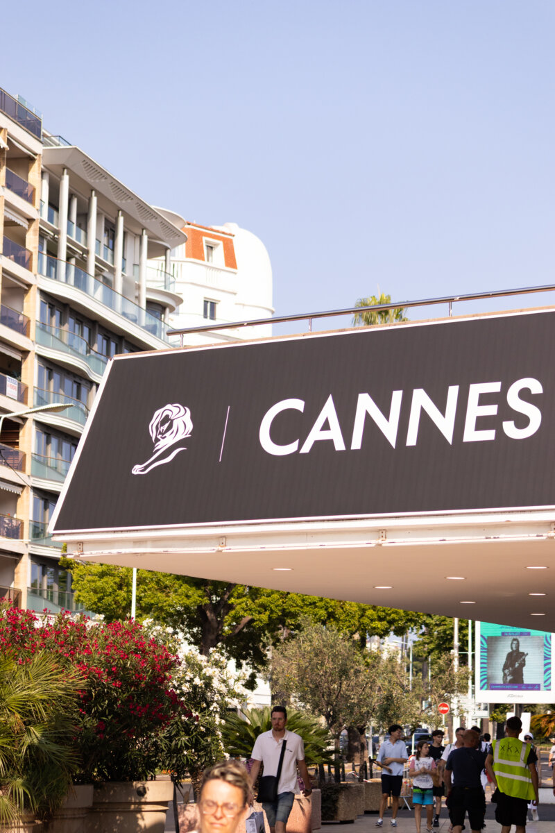 image of cannes sign with buildings in background
