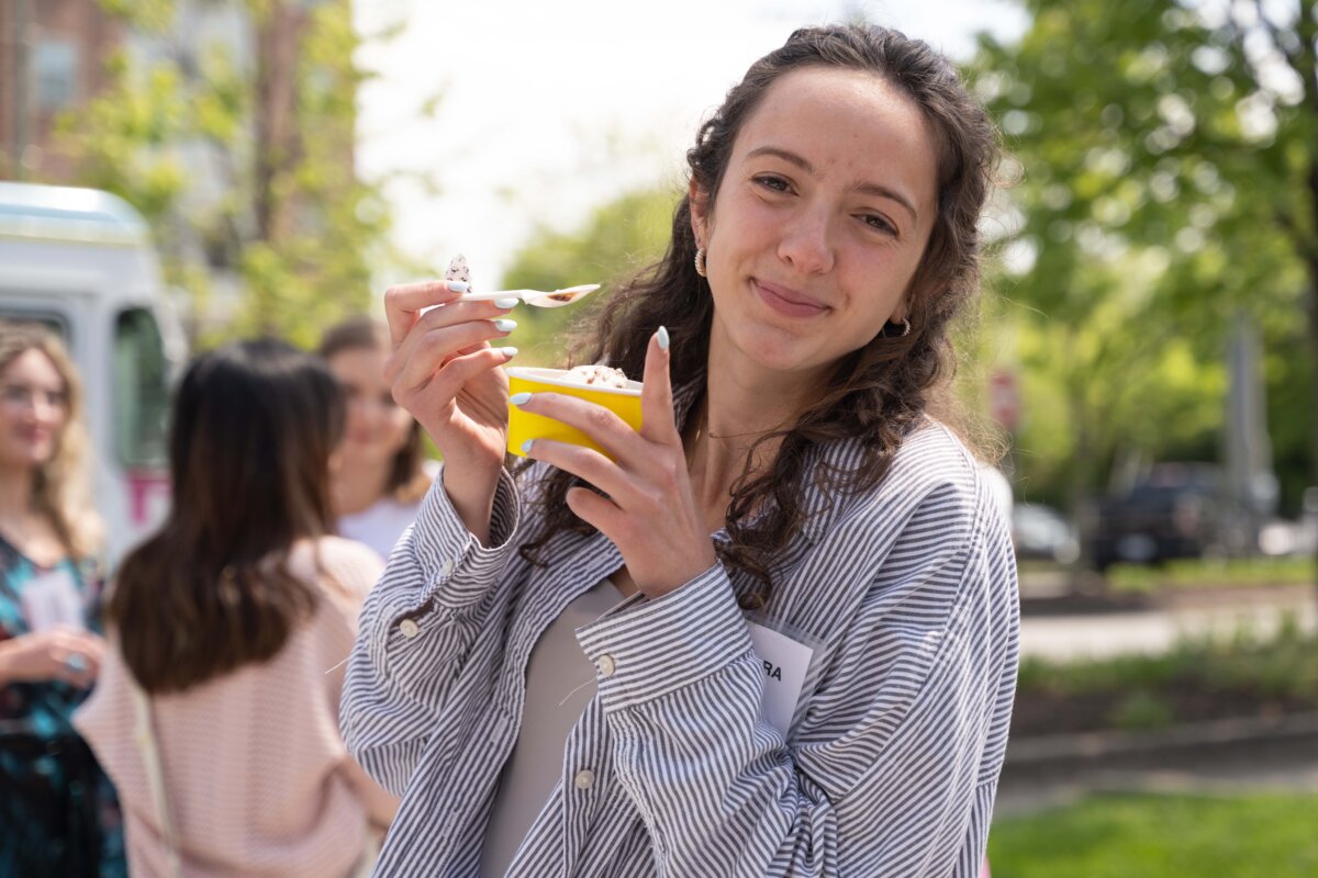 a student eating frozen custard outside
