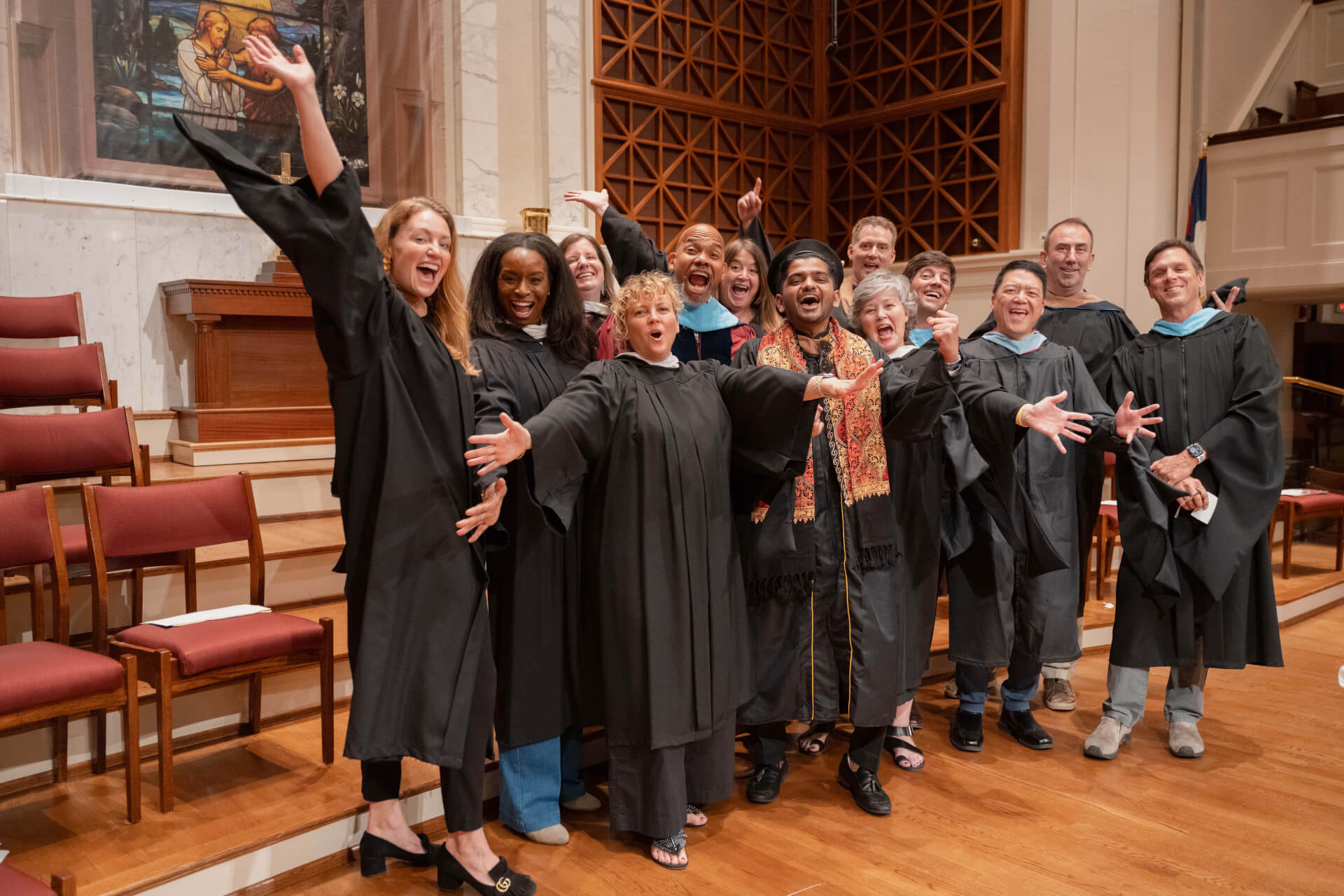 brandcenter faculty holding out arms and smiling