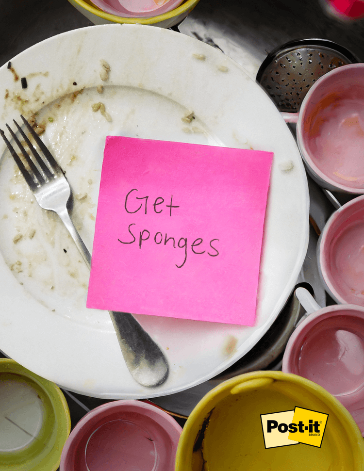 dirty dishes with a pink post it that reads get sponges