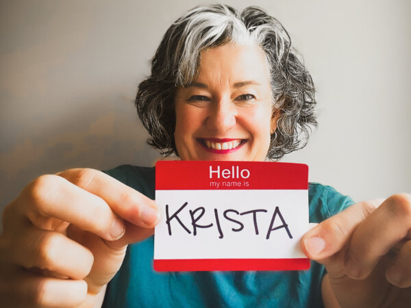 krista holding up a name tag with krista written in sharpie