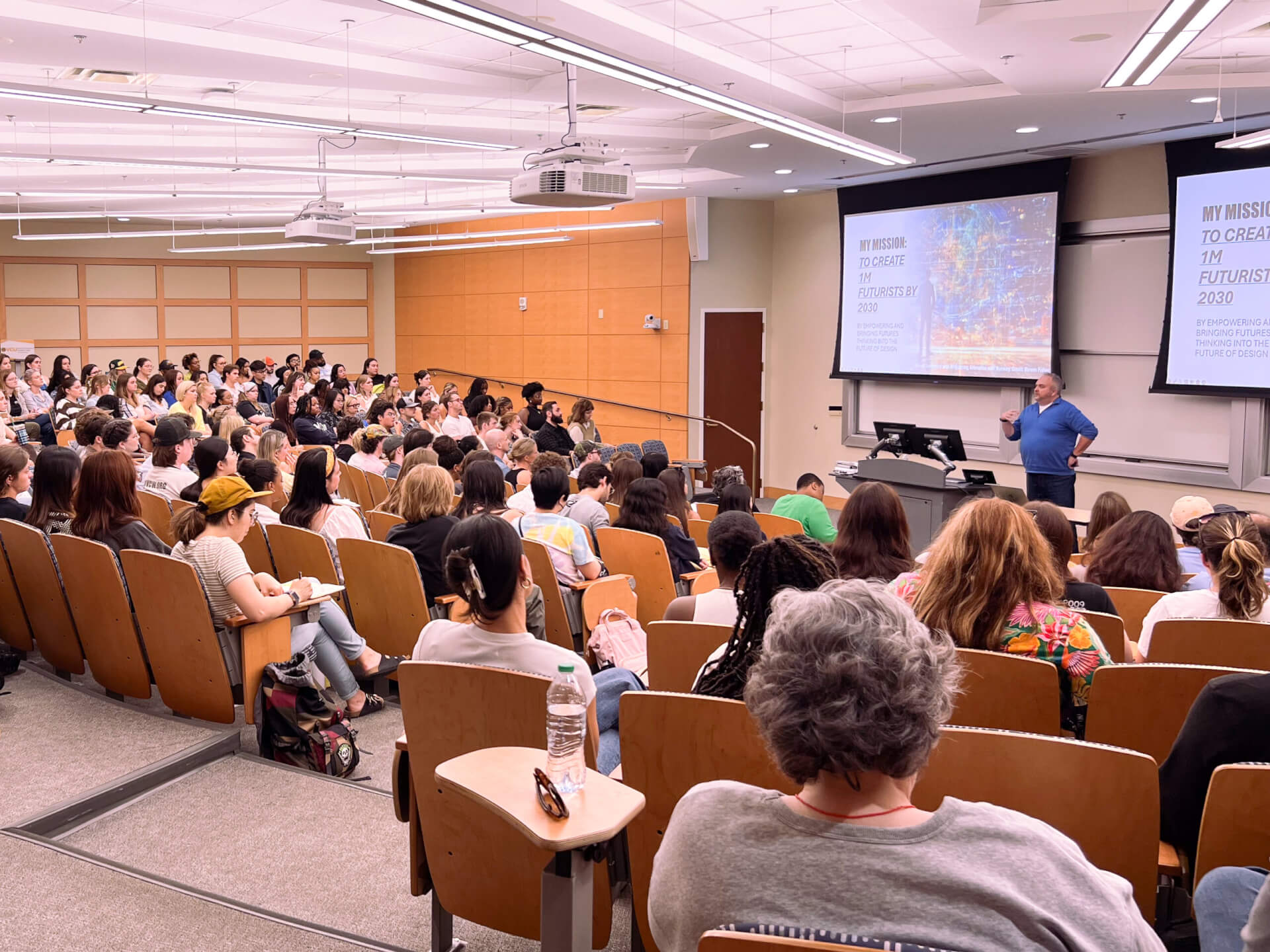 photo of a full auditorium with steven speaking