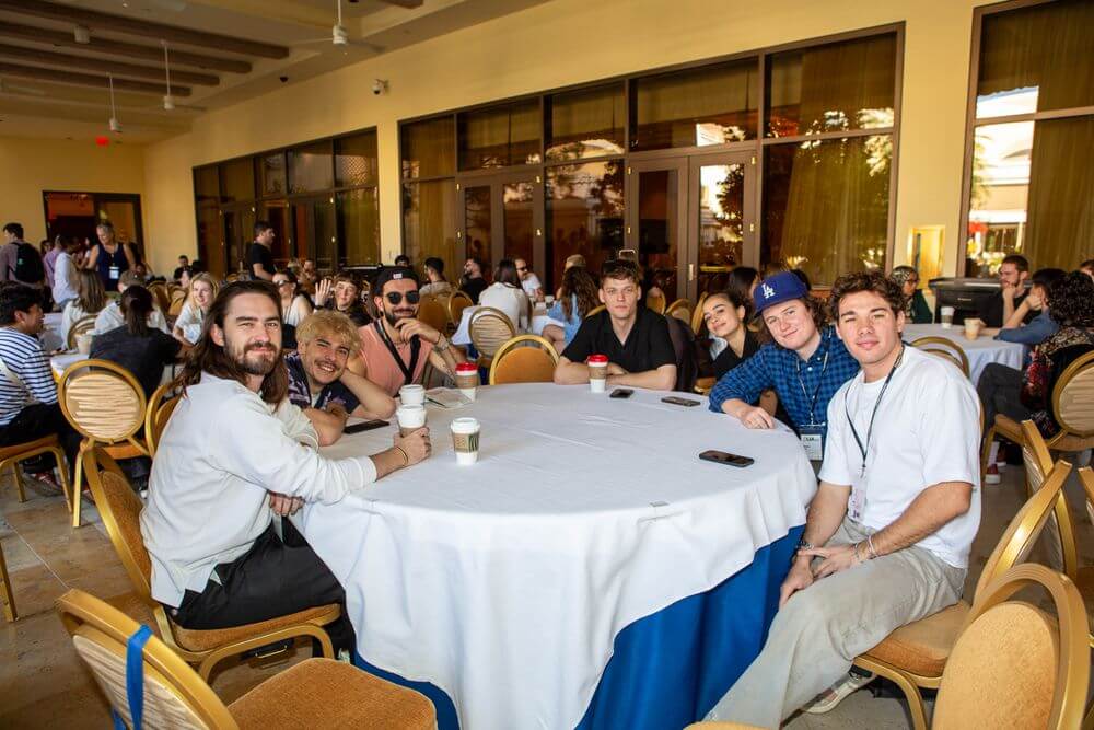 Henry and group of creatives sitting around a table