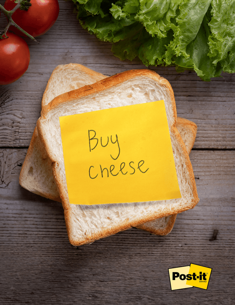 Yellow post it on slice of bread that says buy cheese