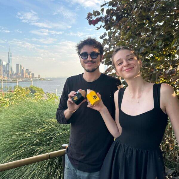 boyan and emma holding yellow and black pencil awards